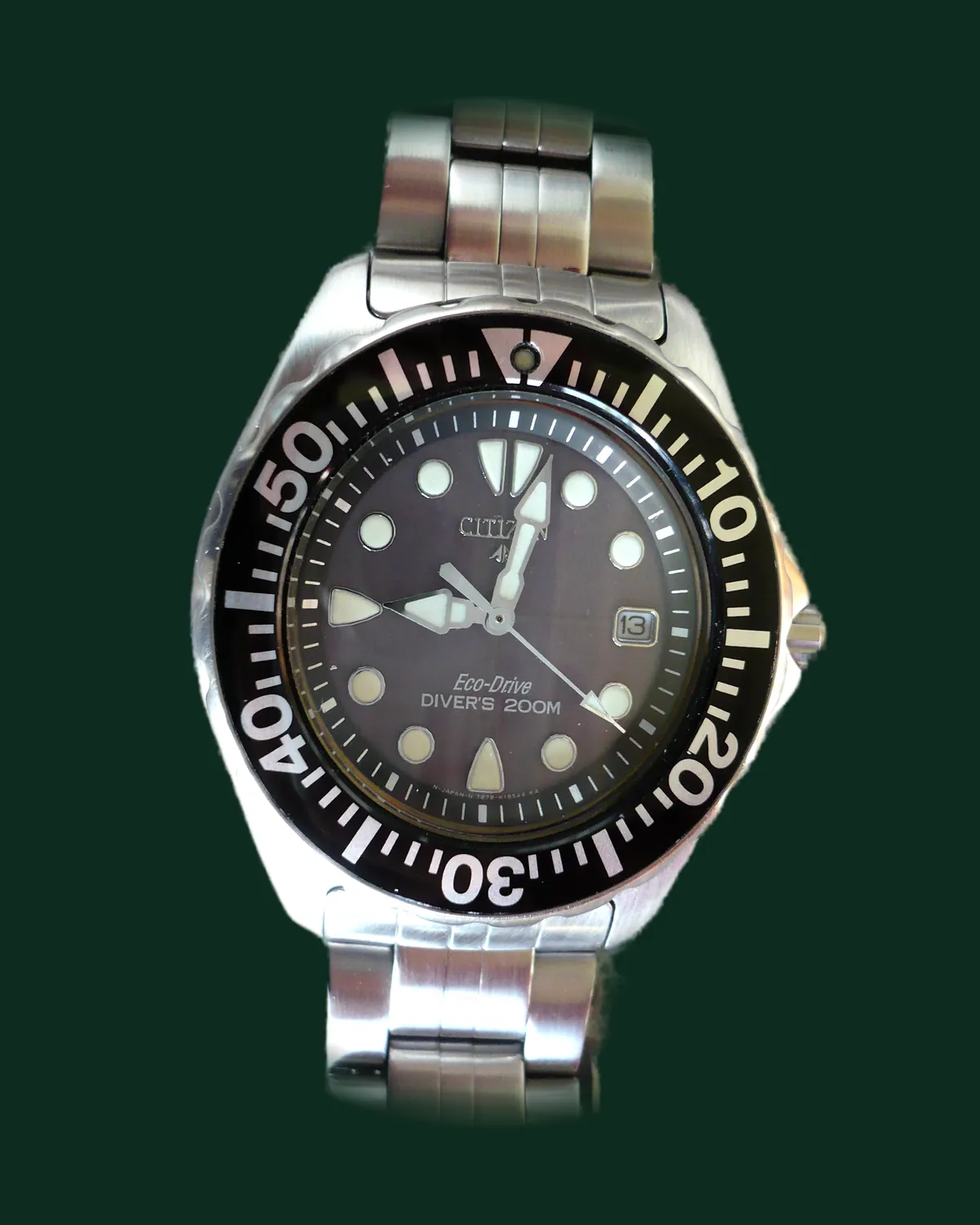 A dive watch with a black dial and a steel bracelet