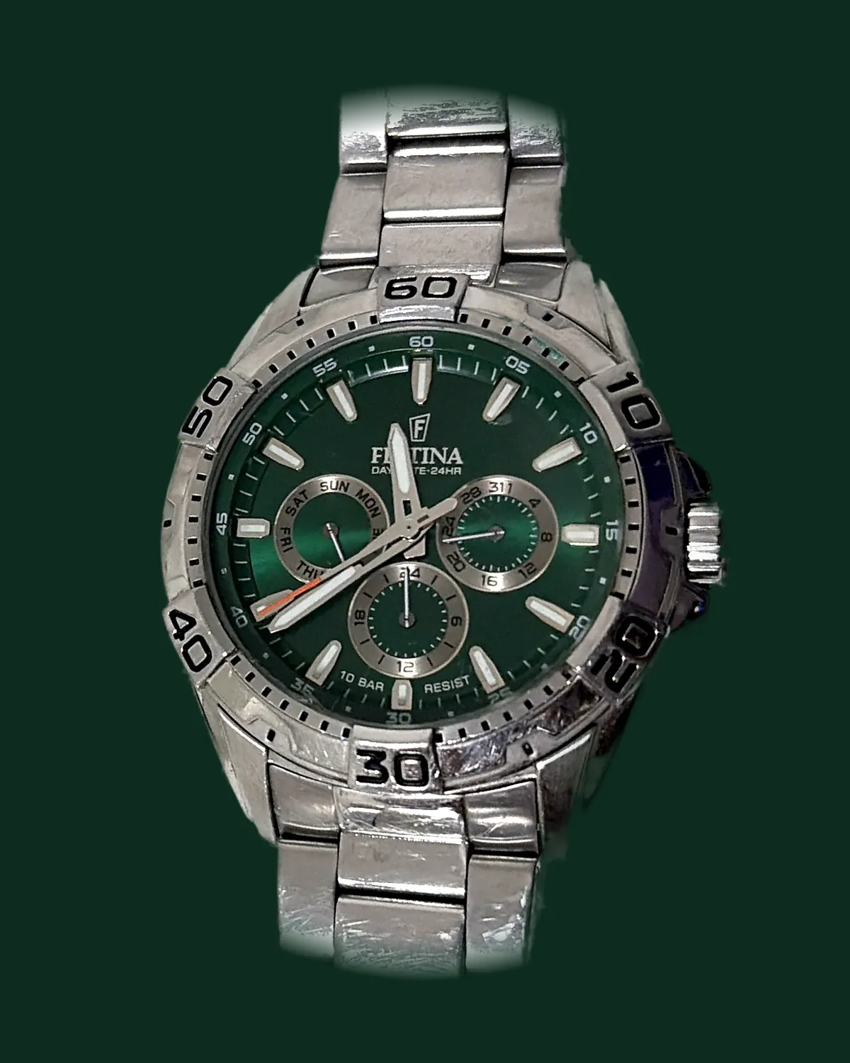 A sports watch with a green dial and a steel bracelet