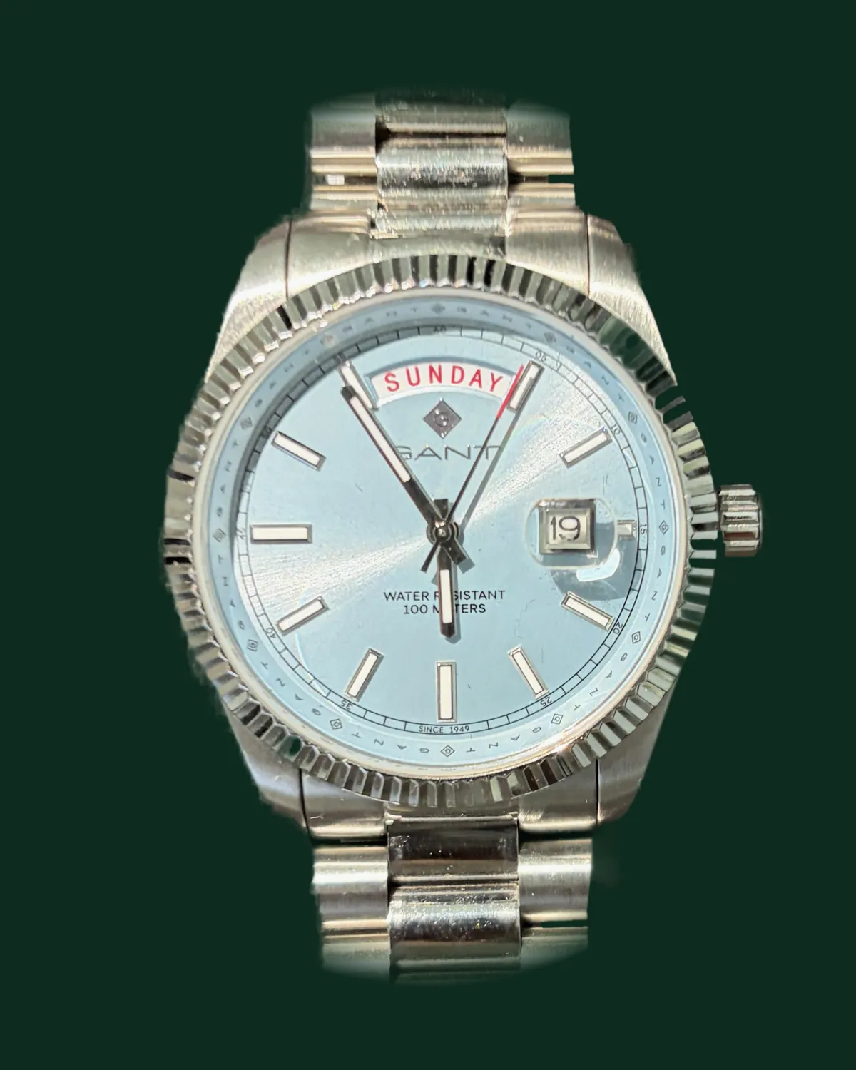 A dress watch with a blue dial and a steel bracelet