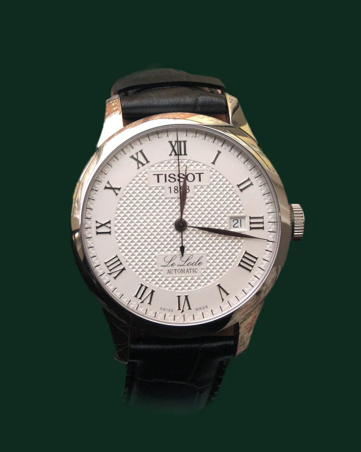 A dress watch with a white dial and a leather strap